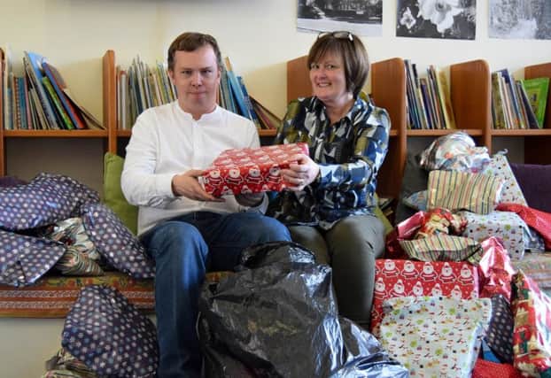 Sharing the Kindness founder Liam Ferguson visits Pen Green in Corby with presents donated by local people who are members of a popular Facebook group. Also picture is Angela Prodger of Pen Green. NNL-181220-142326005
