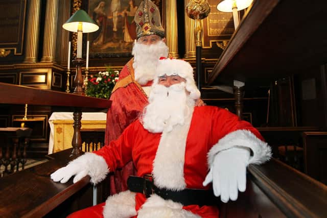 Inside the glorious All Saints Church in Northampton town centre,  St Nicholas poses with Father Christmas before the Feast of St Nick carol concert in 2010.