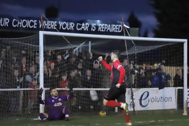 Dan Holman and the Kettering Town supporters celebrate after the striker grabbed their third goal in the 5-0 win over Hitchin Town at Latimer Park. Pictures by Peter Short