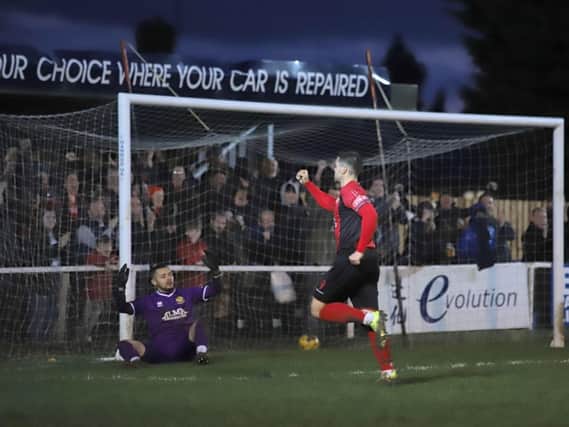 Dan Holman and the Kettering Town supporters celebrate after the striker grabbed their third goal in the 5-0 win over Hitchin Town at Latimer Park. Pictures by Peter Short