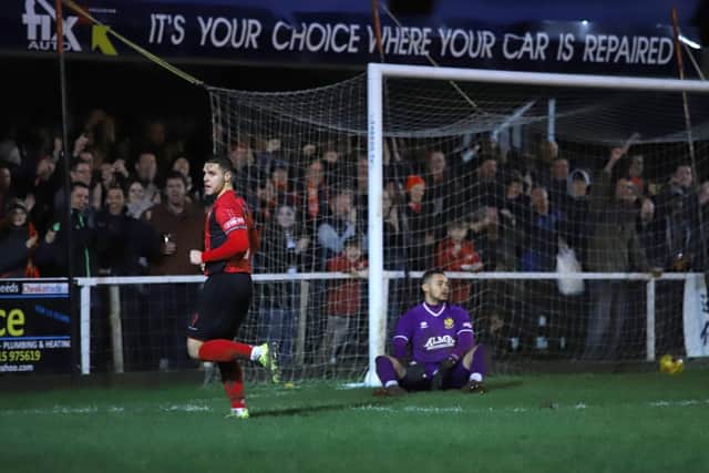 Dan Holman enjoys the moment in front of the Poppies supporters after he grabbed the third goal