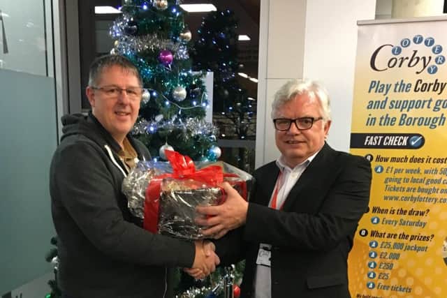 Lottery hamper winner Paul Meredith with Corby Council leader Tom Beattie NNL-181227-154511005