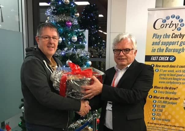 Lottery hamper winner Paul Meredith with Corby Council leader Tom Beattie NNL-181227-154511005