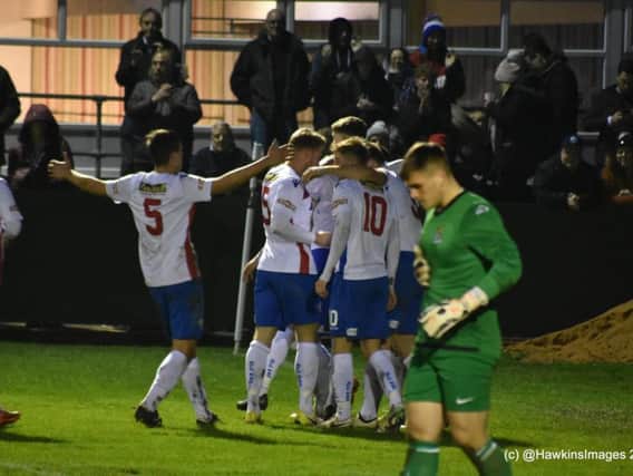 Tom Lorraine is mobbed by his AFC Rushden & Diamonds team-mates after scoring their second goal in the 2-0 win over St Neots Town on Boxing Day. Picture courtesy of HawkinsImages