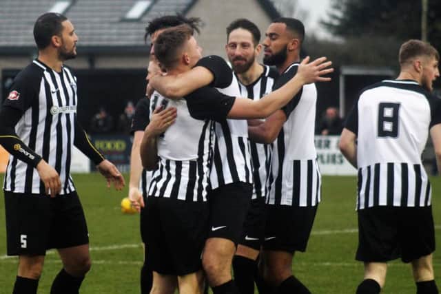 Corby Town celebrate their opening goal, scored by Jordon Crawford, during the 3-0 victory over Coleshill Town. Picture by David Tilley