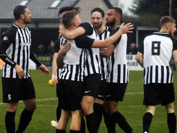 Corby Town celebrate their opening goal, scored by Jordon Crawford, during the 3-0 victory over Coleshill Town. Picture by David Tilley