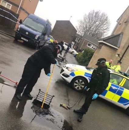 Police search for clues in the aftermath of the shooting.