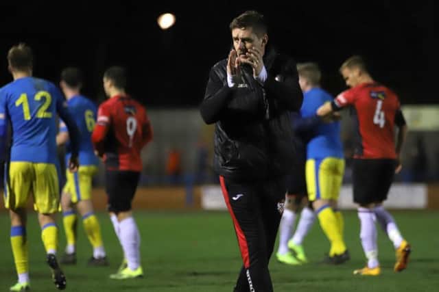 Marcus Law applauds the travelling supporters after Kettering Town claimed a 0-0 draw at King's Lynn Town. Pictures by Peter Short