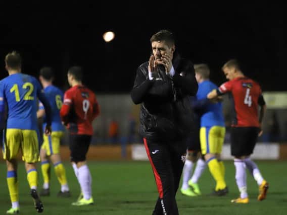 Marcus Law applauds the travelling supporters after Kettering Town claimed a 0-0 draw at King's Lynn Town. Pictures by Peter Short