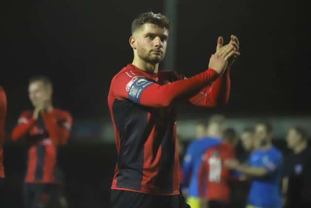 Kettering Town captain Michael Richens applauds the fans after the 0-0 draw at King's Lynn Town on Saturday. He is now set to lead the Poppies out against AFC Rushden & Diamonds on New Year's Day. Picture by Peter Short