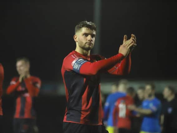 Kettering Town captain Michael Richens applauds the fans after the 0-0 draw at King's Lynn Town on Saturday. He is now set to lead the Poppies out against AFC Rushden & Diamonds on New Year's Day. Picture by Peter Short