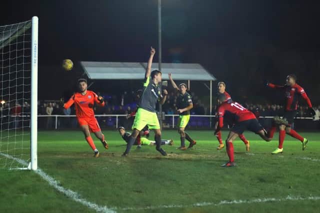 Rhys Hoenes heads home the dramatic winner for Kettering Town as they edged out AFC Rushden & Diamonds 2-1 at a packed Latimer Park. Pictures by Peter Short