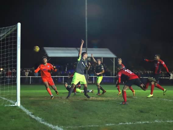 Rhys Hoenes heads home the dramatic winner for Kettering Town as they edged out AFC Rushden & Diamonds 2-1 at a packed Latimer Park. Pictures by Peter Short