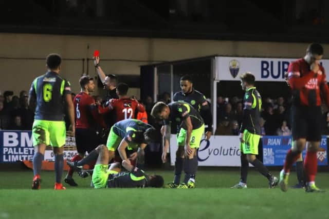 Michael Richens is shown a red card after a challenge on Alex Collard