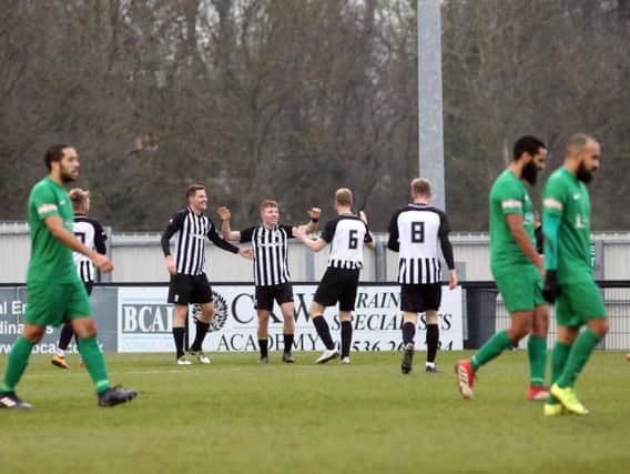 Jordon Crawford takes the congratulations after he opened the scoring in Corby Town's 3-1 success over Kidlington. Pictures by Alison Bagley