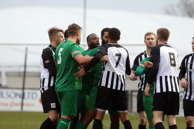 The two sets of players have an exchange of views during the first half