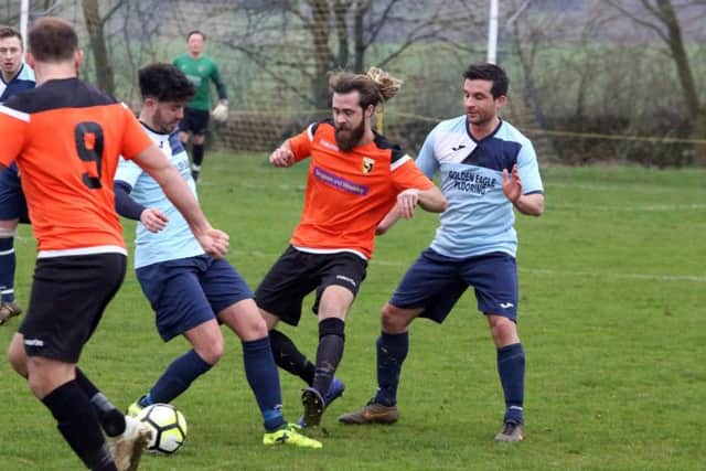 Kettering Nomads and Rushden & Higham United battle for possession