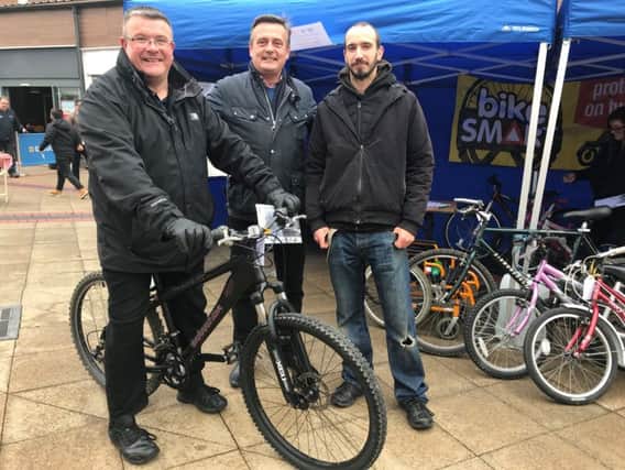 Adam Barron (first cycle recipient), Corby Town Shopping & Willow Place Centre Director Dan Pickard and Paul Young (Home-Start Dad), who repaired all of the bikes. NNL-191101-155759005