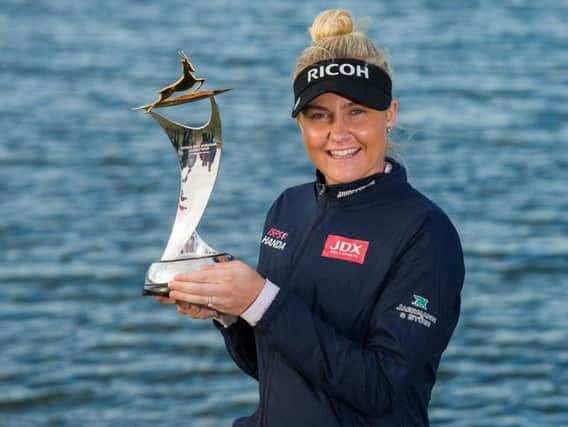 Charley Hull shows off the trophy after she claimed victory in the Fatima Bint Mubarak Ladies Open. Picture courtesy of Tristan Jones/Ladies European Tour (LET)