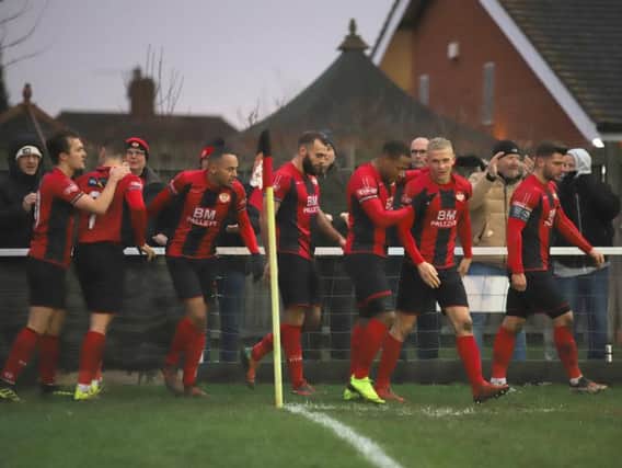 The Kettering Town players celebrate after Aaron O'Connor scored the only goal of the game to give them a 1-0 success over Royston Town at Latimer Park. Pictures by Peter Short