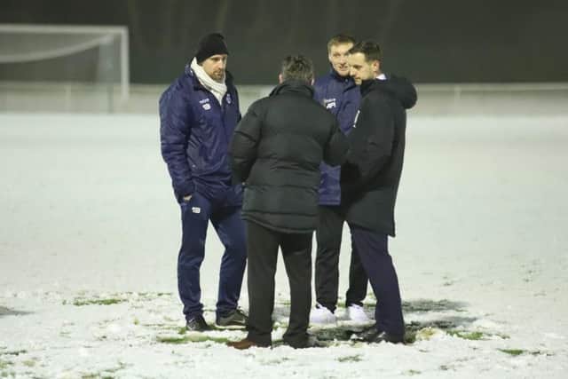 Steve Kinniburgh and assistant-manager Ashley Robinson talk things over with the match referee before Corby Town's midweek clash at Welwyn Garden City was postponed due to snow. Picture by Peter Short