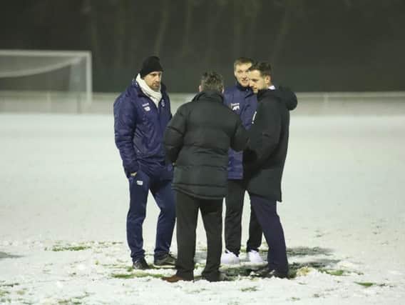 Steve Kinniburgh and assistant-manager Ashley Robinson talk things over with the match referee before Corby Town's midweek clash at Welwyn Garden City was postponed due to snow. Picture by Peter Short