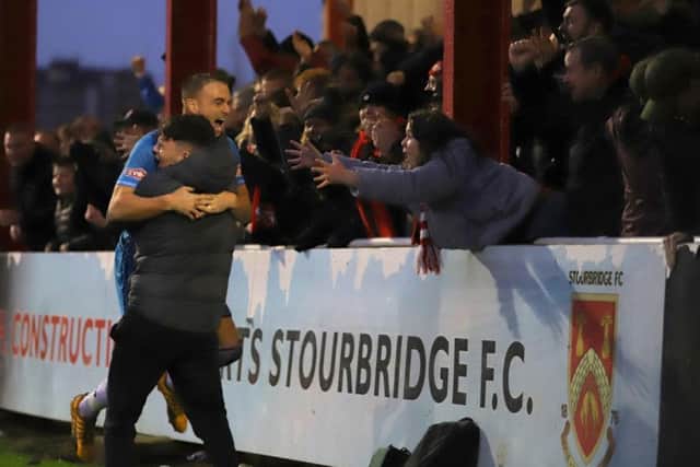 Brett Solkhon celebrates with the Kettering Town fans after he scored the equaliser in the crucial 2-1 success at title rivals Stourbridge. Pictures by Peter Short