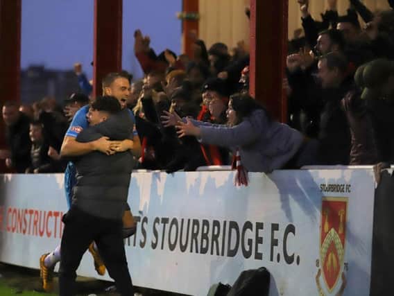 Brett Solkhon celebrates with the Kettering Town fans after he scored the equaliser in the crucial 2-1 success at title rivals Stourbridge. Pictures by Peter Short