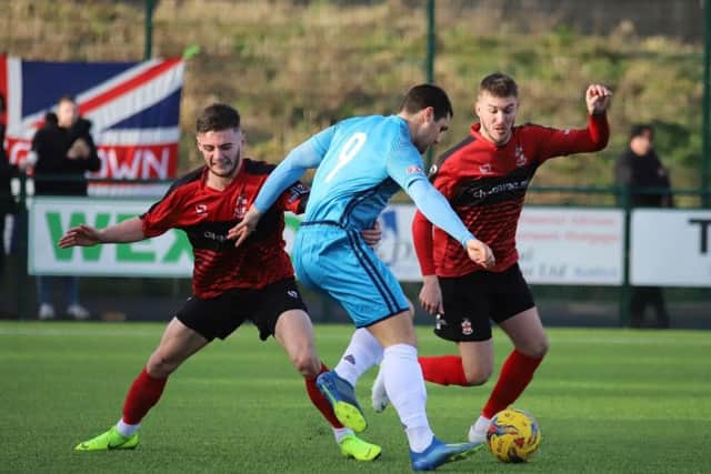 Dan Holman takes on two Redditch United defenders during Kettering Town's 4-1 victory. Picture by Peter Short