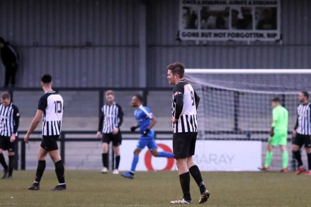 The Corby Town players look dejected after Dunstable Town scored the winner in their 2-1 success at Steel Park. Pictures by Alison Bagley