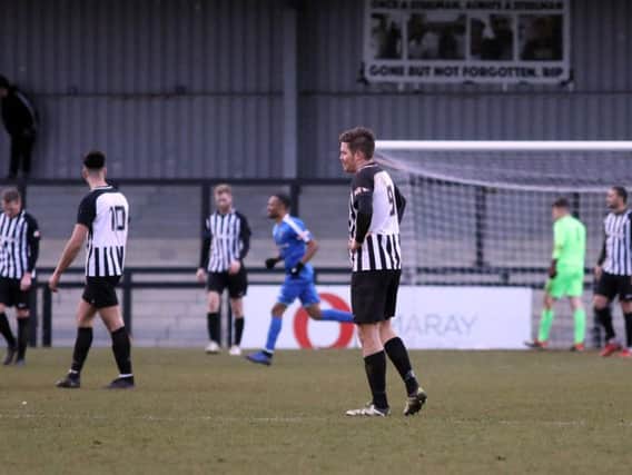 The Corby Town players look dejected after Dunstable Town scored the winner in their 2-1 success at Steel Park. Pictures by Alison Bagley