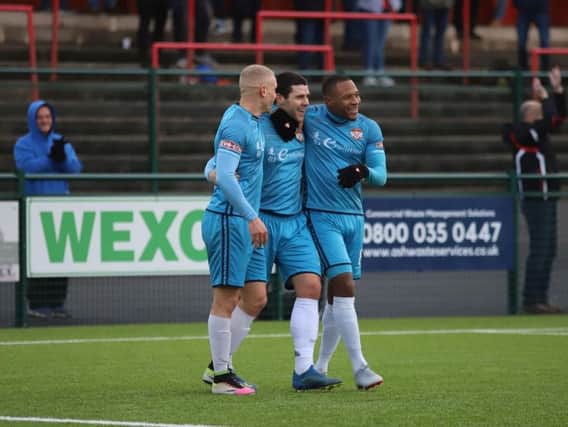 Dan Holman is congratulated by Lindon Meikle and Aaron O'Connor after he scored Kettering Town's third goal in the 4-1 success at Redditch United. Picture by Peter Short