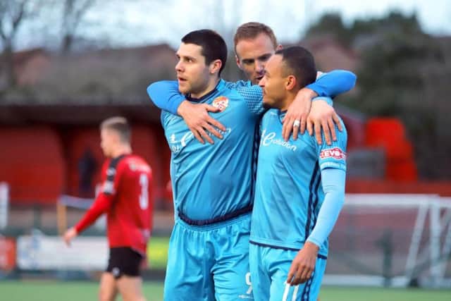 Dan Holman, Brett Solkhon and Rhys Hoenes celebrate the latter's second goal at Redditch