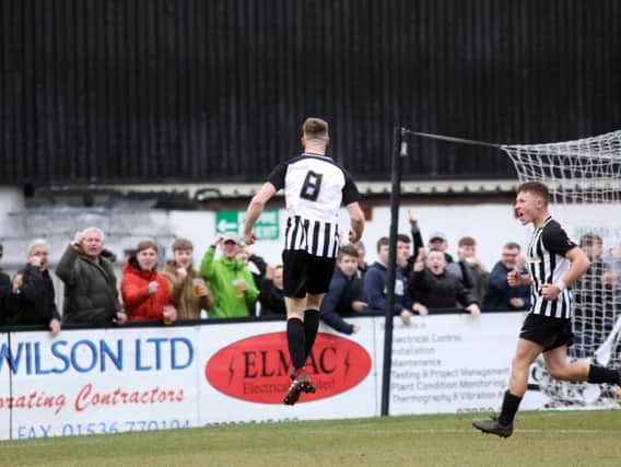 Connor Kennedy jumps for joy after scoring Corby Town's third goal in the 3-2 victory over Didcot Town at Steel Park. Pictures by Alison Bagley