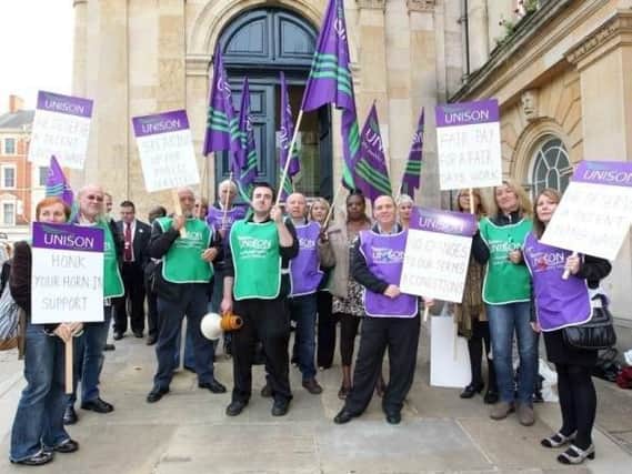 Unions say they want a return to national pay and conditions for Northamptonshire County Council staff.