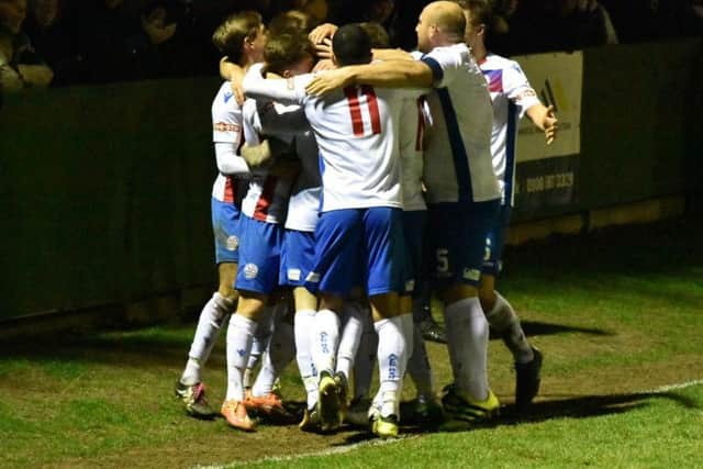 Sam Johnson is mobbed by his AFC Rushden & Diamonds team-mates after he scored the second goal in the fine 2-0 victory over Stratford Town at Hayden Road. Picture courtesy of HawkinsImages