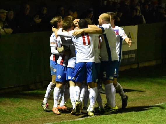 Sam Johnson is mobbed by his AFC Rushden & Diamonds team-mates after he scored the second goal in the fine 2-0 victory over Stratford Town at Hayden Road. Picture courtesy of HawkinsImages