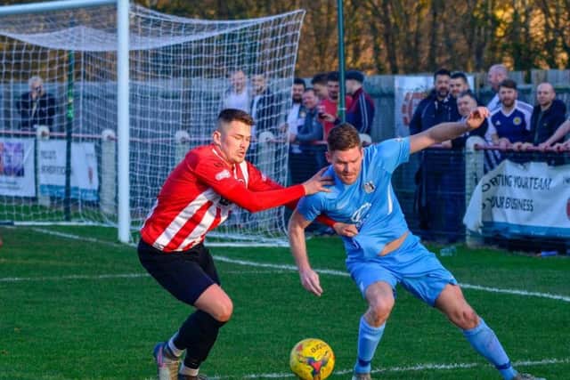 Elliot Sandy battles for possession with a Kempston opponent