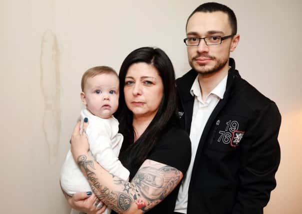 Newbuild Nightmare: Corby: Stacie and Marc Smith with daughter Skylar, 6 months, in their new build house on Priors Hall Park, Corby which has had a large number of problems including holes in the floors. 
Tuesday, March 5th 2019 NNL-190503-192154009