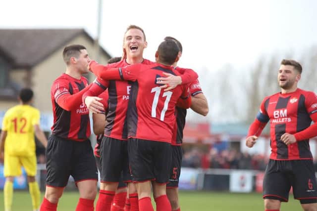 Brett Solkhon takes the congratulations after he scored Kettering Town's third goal in the 3-0 success over Banbury United at Latimer Park. Pictures by Peter Short