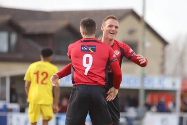 Brett Solkhon celebrates with Dan Holman after the Poppies' third goal