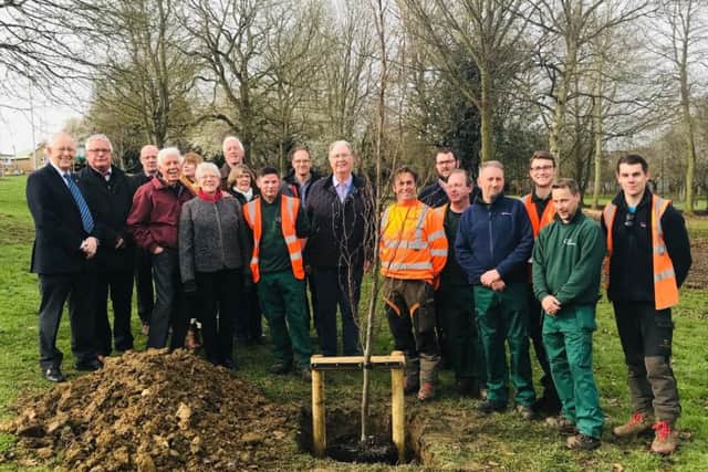 Corby Borough and Kettering Borough councillors together with officers from the new shared service team and members of the Friends of Coronation Park group plant new trees as part of the makeover