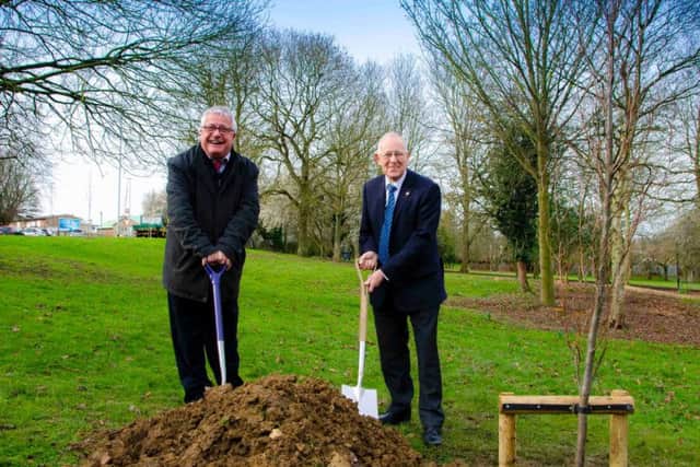 Corby Borough Councillor Mark Pengelly and Kettering Borough Councillor Ian Jelley plant one of the new trees at Coronation Park