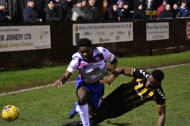 Substitute Ben Acquaye is tackled during AFC Rushden & Diamonds 2-0 defeat at Rushall Olympic on Monday night. Picture courtesy of HawkinsImages