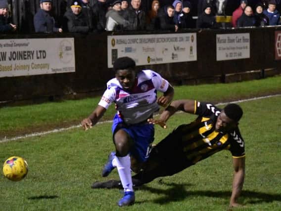 Substitute Ben Acquaye is tackled during AFC Rushden & Diamonds 2-0 defeat at Rushall Olympic on Monday night. Picture courtesy of HawkinsImages