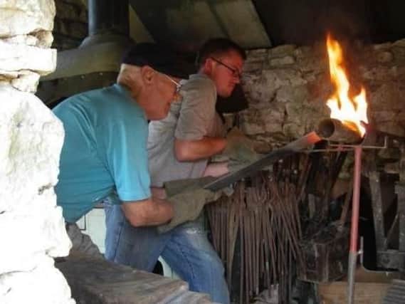 Martyn Paul Steele (right) at work at the forge