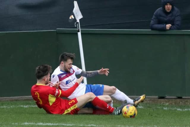Diamonds' man-of-the-match Sam Johnson is challenged by Needham Market's Callum Sturgess