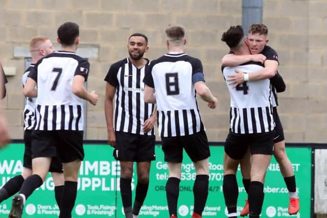 Jordon Crawford takes the congratulations after scoring the first of his three goals in Corby Town's 5-2 win over North Leigh at Steel Park. Pictures by Alison Bagley
