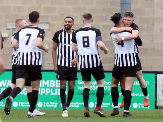 Jordon Crawford takes the congratulations after scoring the first of his three goals in Corby Town's 5-2 win over North Leigh at Steel Park. Pictures by Alison Bagley