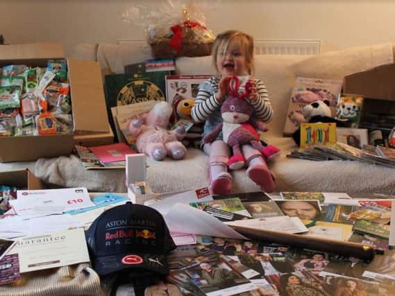 Three-year-old Imogen with some of the items in the upcoming charity auction